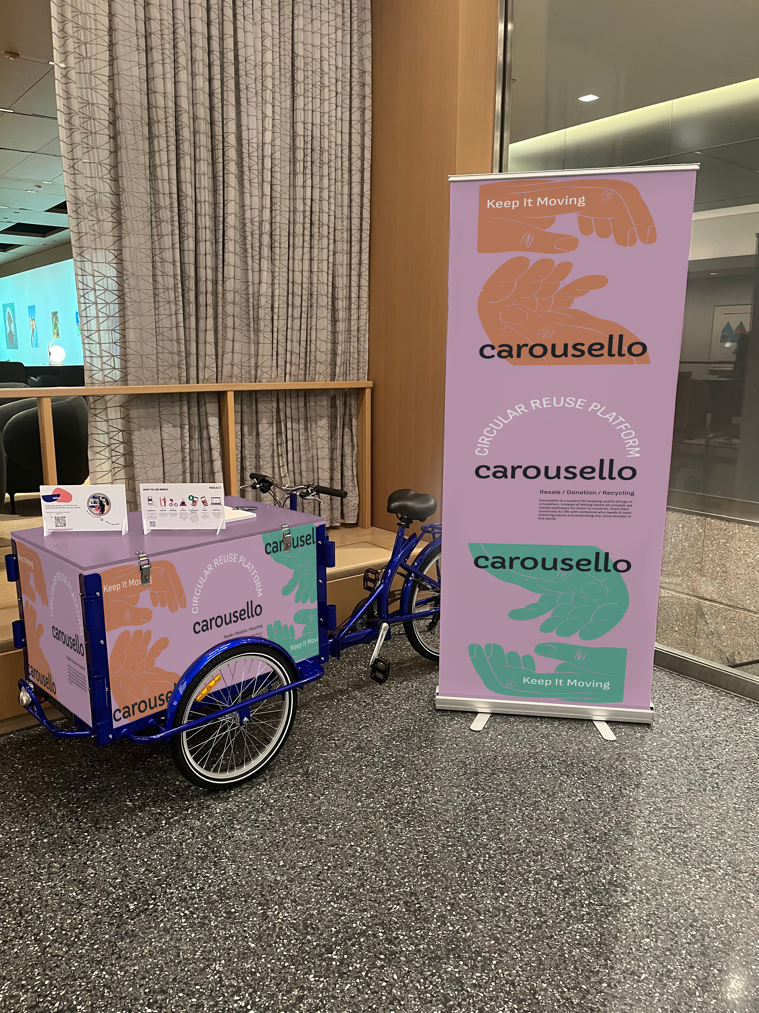 An Carousello company kiosk is installed in the lobby of an office.